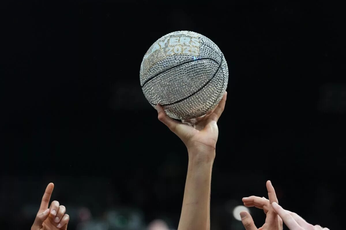 Nov 26, 2025; Las Vegas, NV, USA; A detailed view of the 2025 Players Era Festival trophy lifted up by members of Michigan Wolverines after the championship game against the Gonzaga Bulldogs at MGM Grand Garden Arena. Mandatory Credit: Kirby Lee-Imagn Images