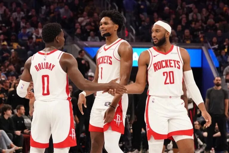Nov 26, 2025; San Francisco, California, USA; Houston Rockets guard Aaron Holiday (0), guard-forward Amen Thompson (1), and guard Josh Okogie (20) huddle during a break in the action against the Golden State Warriors in the fourth quarter at Chase Center. Mandatory Credit: David Gonzales-Imagn Images