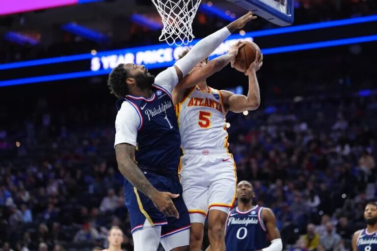 Nov 30, 2025; Philadelphia, Pennsylvania, USA; Philadelphia 76ers center Andre Dummond (1) defends a shot against Atlanta Hawks guard Dyson Daniels (5) in the first quarter at Xfinity Mobile Arena. Mandatory Credit: Kyle Ross-Imagn Images