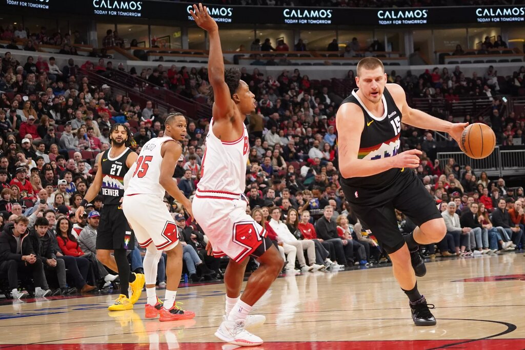 Chicago Bulls guard Collin Sexton (2) defends Denver Nuggets center Nikola Jokic (15) during the first half at United Center.