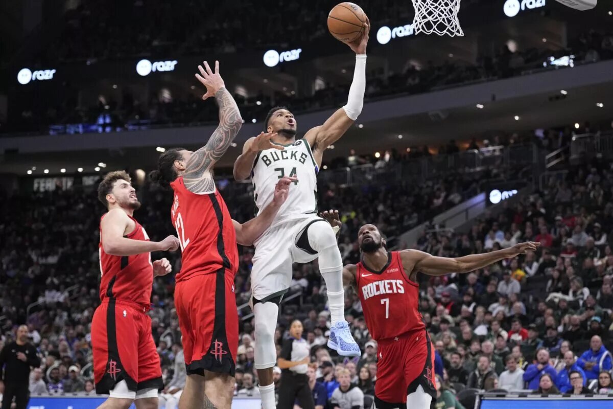 Milwaukee Bucks forward Giannis Antetokounmpo (34) drives to the basket against Houston Rockets center Steven Adams (12) and Houston Rockets forward Kevin Durant (7) in the second half at Fiserv Forum.