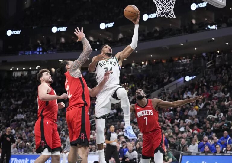 Milwaukee Bucks forward Giannis Antetokounmpo (34) drives to the basket against Houston Rockets center Steven Adams (12) and Houston Rockets forward Kevin Durant (7) in the second half at Fiserv Forum.