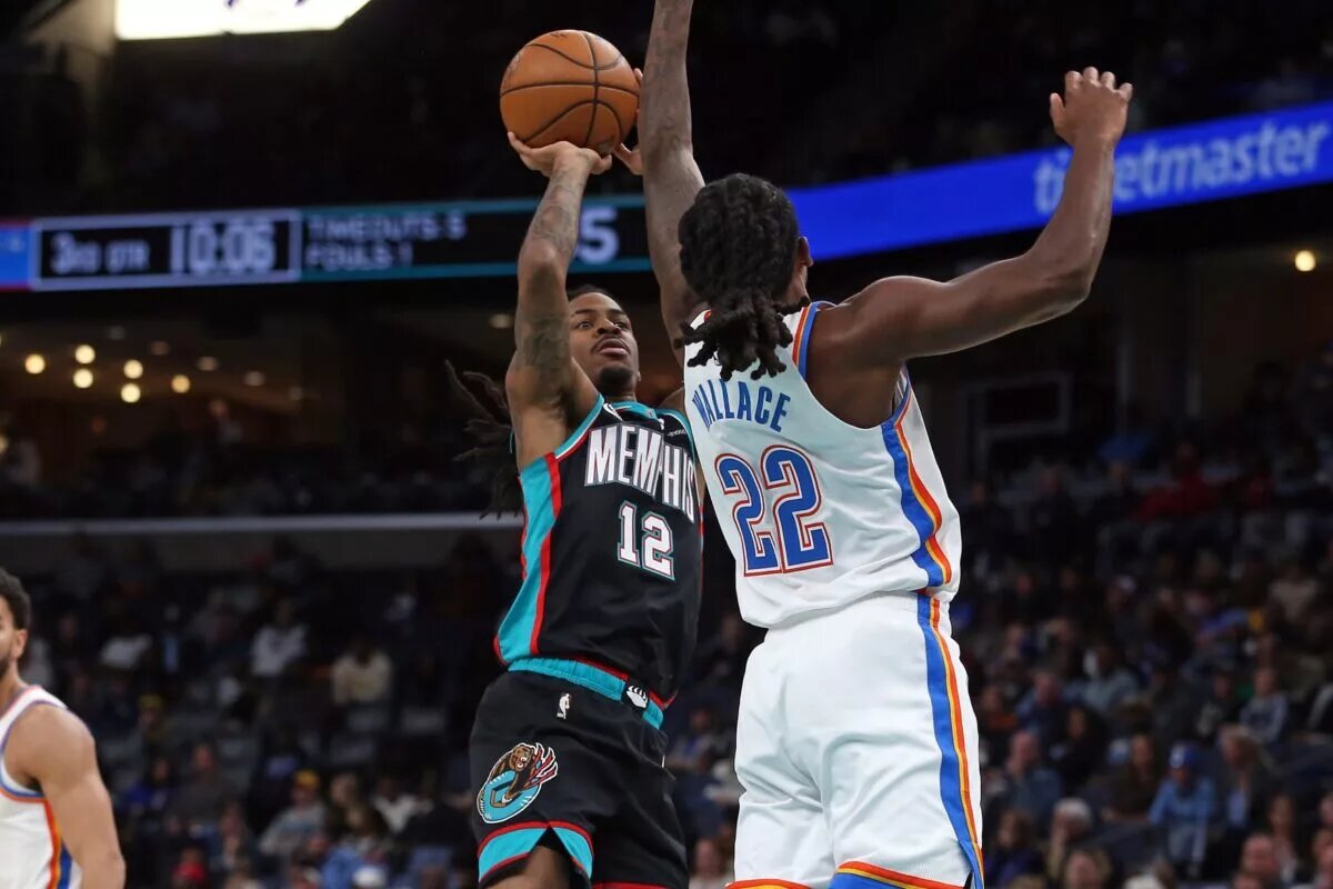 Nov 9, 2025; Memphis, Tennessee, USA; Memphis Grizzlies guard Ja Morant (12) shoots as Oklahoma City Thunder guard Cason Wallace (22) defends during the third quarter at FedExForum. Mandatory Credit: Petre Thomas-Imagn Images