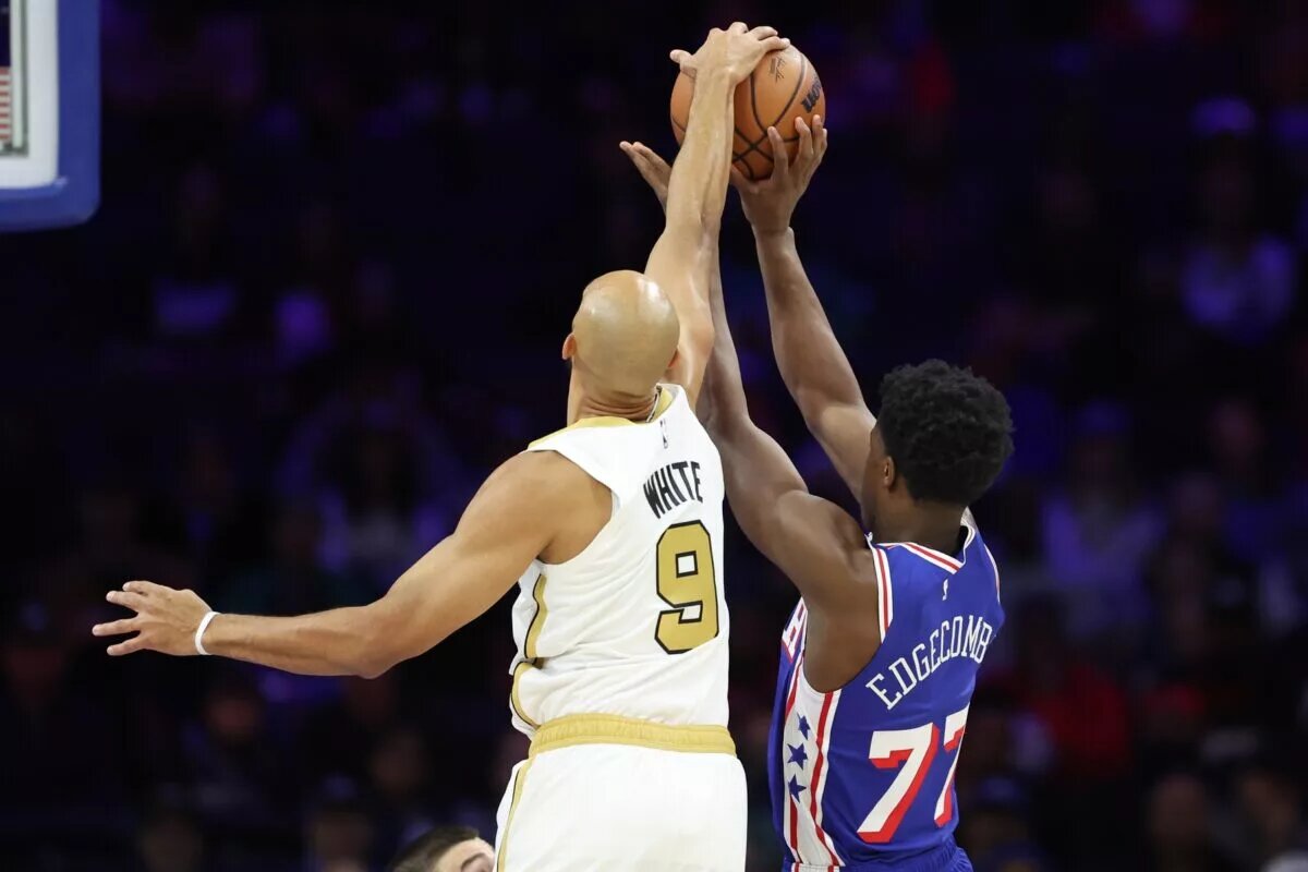 Nov 11, 2025; Philadelphia, Pennsylvania, USA; Boston Celtics guard Derrick White (9) blocks the shot of Philadelphia 76ers guard VJ Edgecombe (77) during the first quarter at Xfinity Mobile Arena. Mandatory Credit: Bill Streicher-Imagn Images