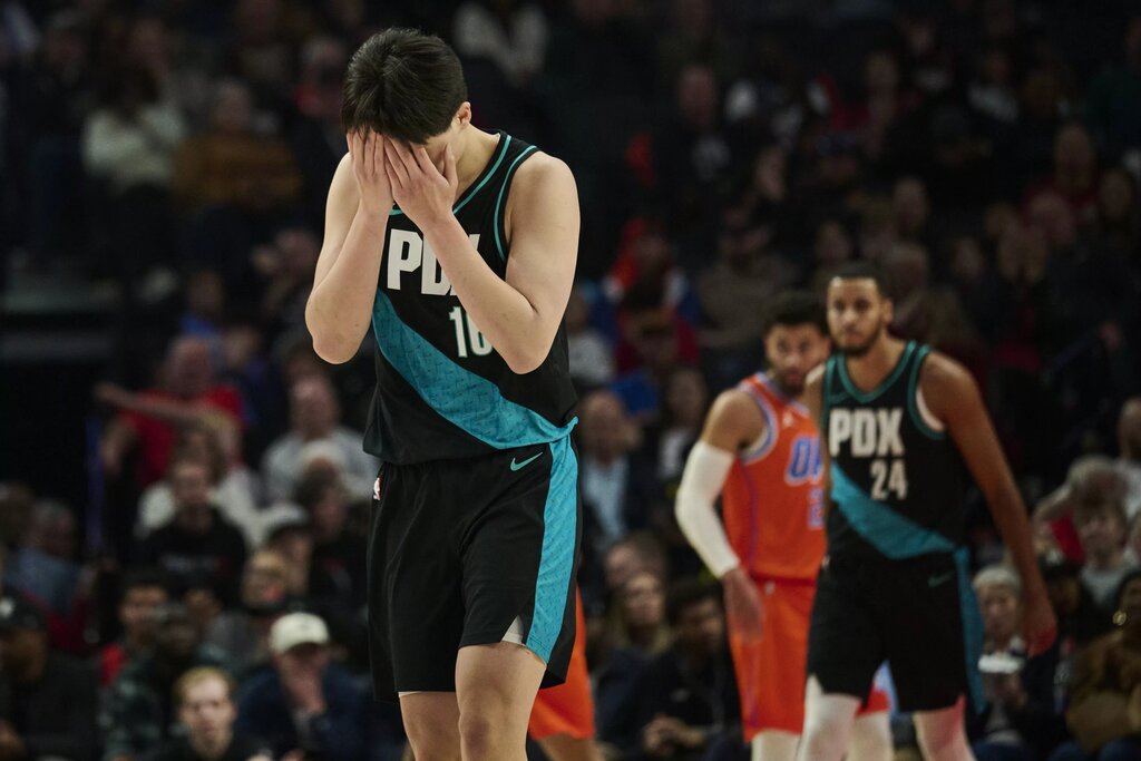 Nov 30, 2025; Portland, Oregon, USA; Portland Trail Blazers center Yang Hansen (16) reacts after missing a three point basket during the first half against the Oklahoma City Thunder at Moda Center. Mandatory Credit: Troy Wayrynen-Imagn Images