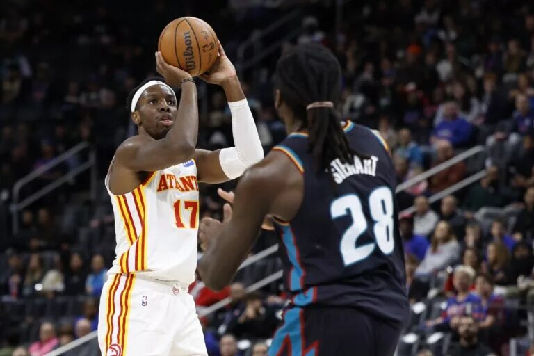Dec 1, 2025; Detroit, Michigan, USA; Atlanta Hawks forward Onyeka Okongwu (17) shoots over Detroit Pistons forward Isaiah Stewart (28) in the first half t Little Caesars Arena. Mandatory Credit: Rick Osentoski-Imagn Images