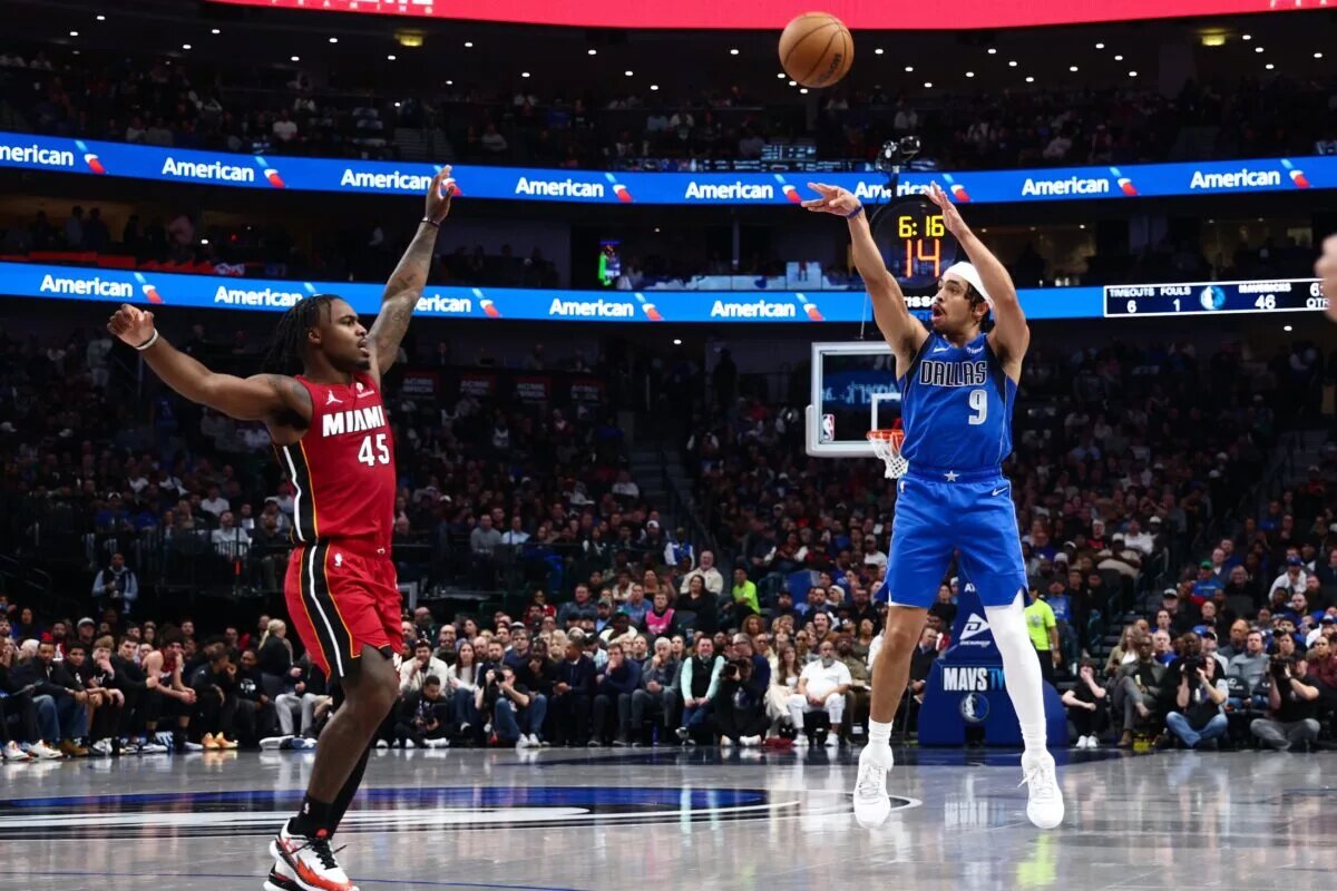 Dec 3, 2025; Dallas, Texas, USA; Dallas Mavericks guard Ryan Nembhard (9) shoots over Miami Heat guard Davion Mitchell (45) during the first half at American Airlines Center. Mandatory Credit: Kevin Jairaj-Imagn Images