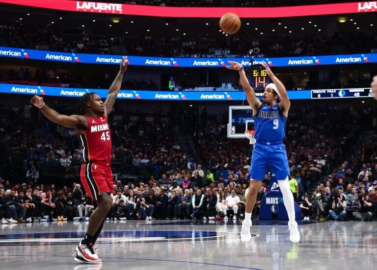Dec 3, 2025; Dallas, Texas, USA; Dallas Mavericks guard Ryan Nembhard (9) shoots over Miami Heat guard Davion Mitchell (45) during the first half at American Airlines Center. Mandatory Credit: Kevin Jairaj-Imagn Images