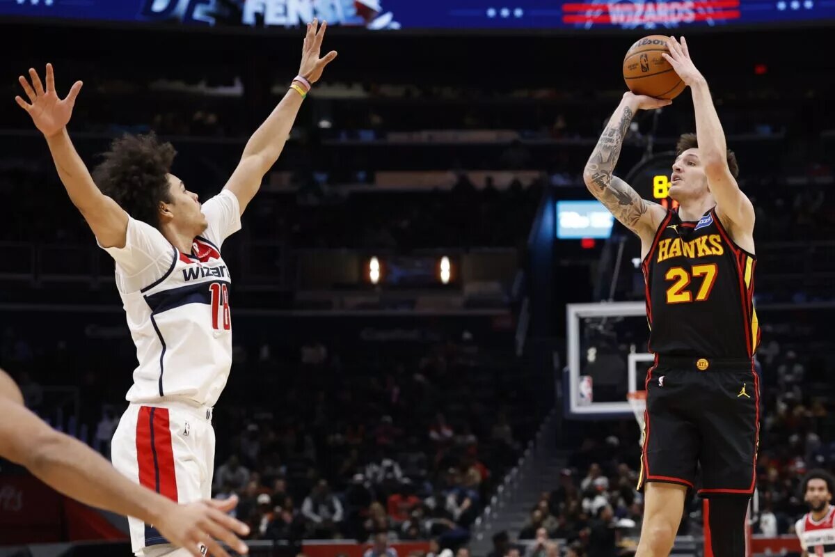 Atlanta Hawks guard Vit Krejci (27) shoots the ball as Washington Wizards forward Kyshawn George (18) defends in the second half at Capital One Arena.