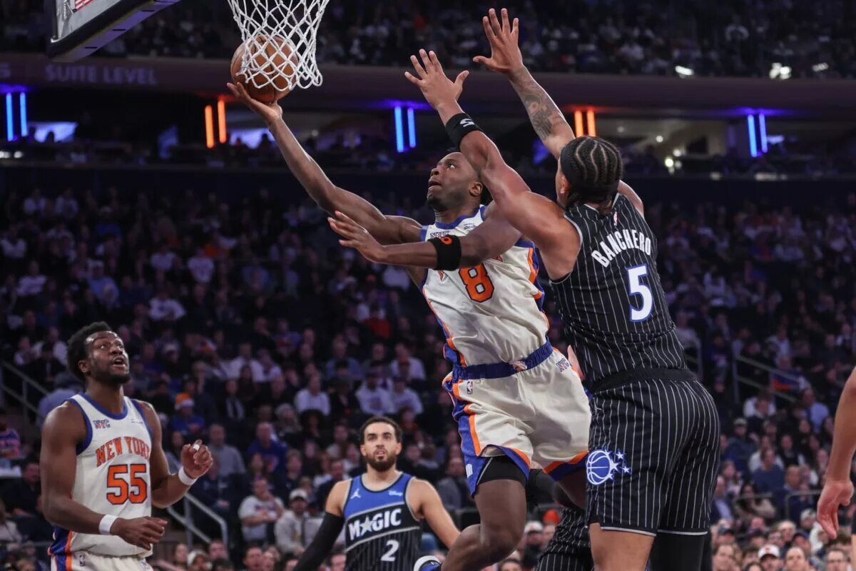 New York Knicks forward Og Anunoby (8) drives past Orlando Magic forward Paolo Banchero (5) in the first quarter at Madison Square Garden.