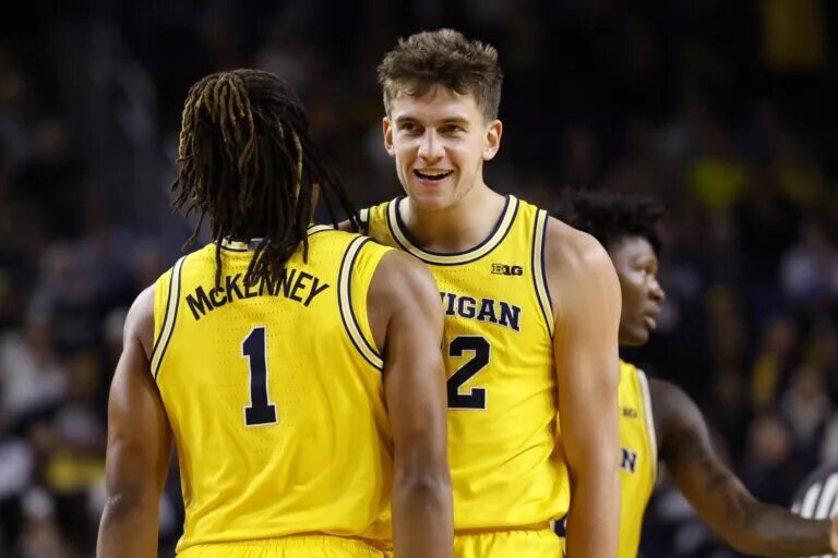 Dec 9, 2025; Ann Arbor, Michigan, USA; Michigan Wolverines forward Will Tschetter (42) receives congratulations from guard Trey McKenney (1) after scoring in the first half against the Villanova Wildcats at Crisler Center. Mandatory Credit: Rick Osentoski-Imagn Images