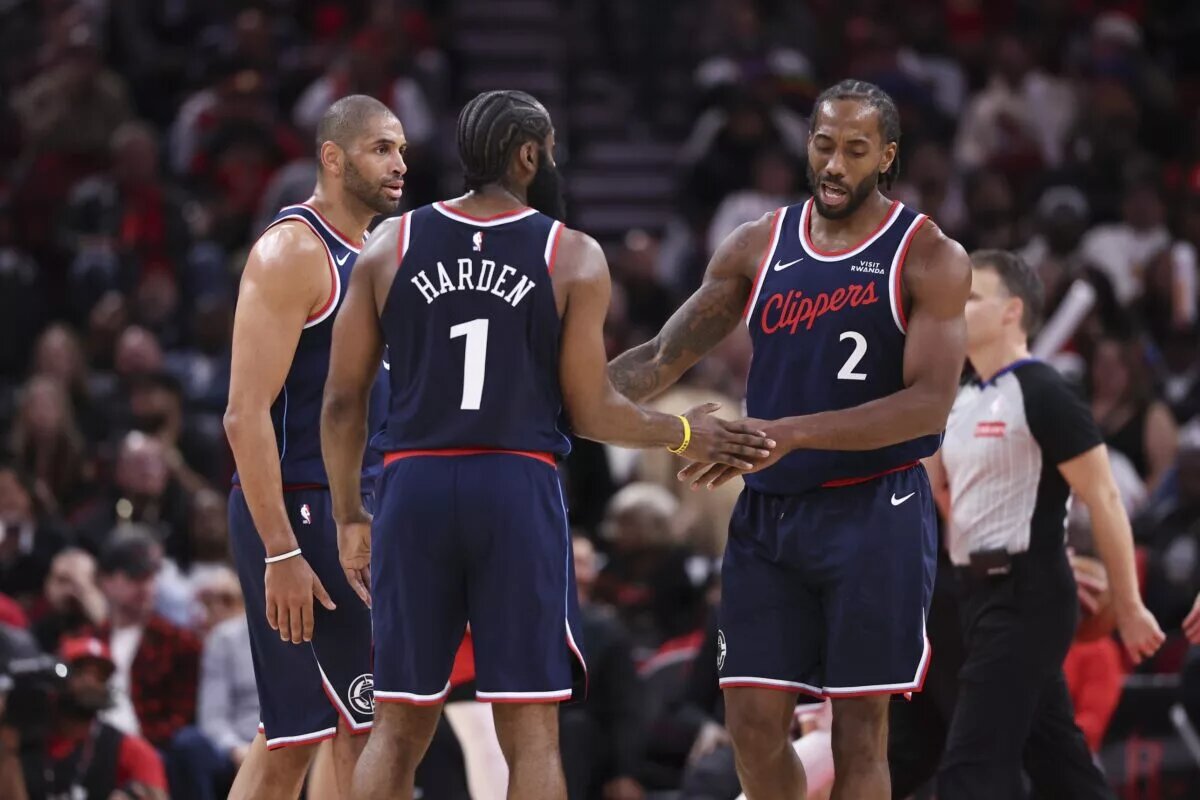 Dec 11, 2025; Houston, Texas, USA; Los Angeles Clippers forward Kawhi Leonard (2) reacts with guard James Harden (1) and forward Nicolas Batum (33) after a play during the fourth quarter against the Houston Rockets at Toyota Center. Mandatory Credit: Troy Taormina-Imagn Images