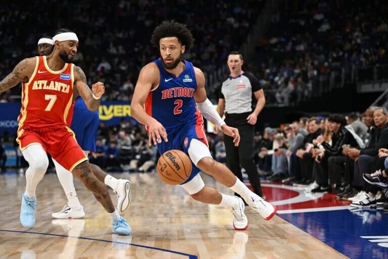 Detroit Pistons guard Cade Cunningham (2) drives past Atlanta Hawks guard Nickeil Alexander-Walker (7) in the first quarter at Little Caesars Arena.