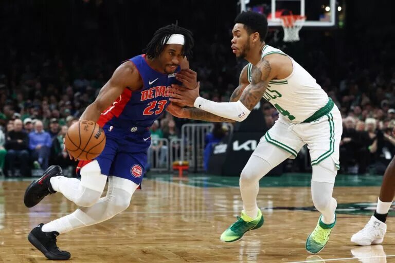 Dec 15, 2025; Boston, Massachusetts, USA; Detroit Pistons guard Jaden Ivey (23) drives on Boston Celtics guard Anfernee Simons (4) during the first quarter at TD Garden. Mandatory Credit: Winslow Townson-Imagn Images