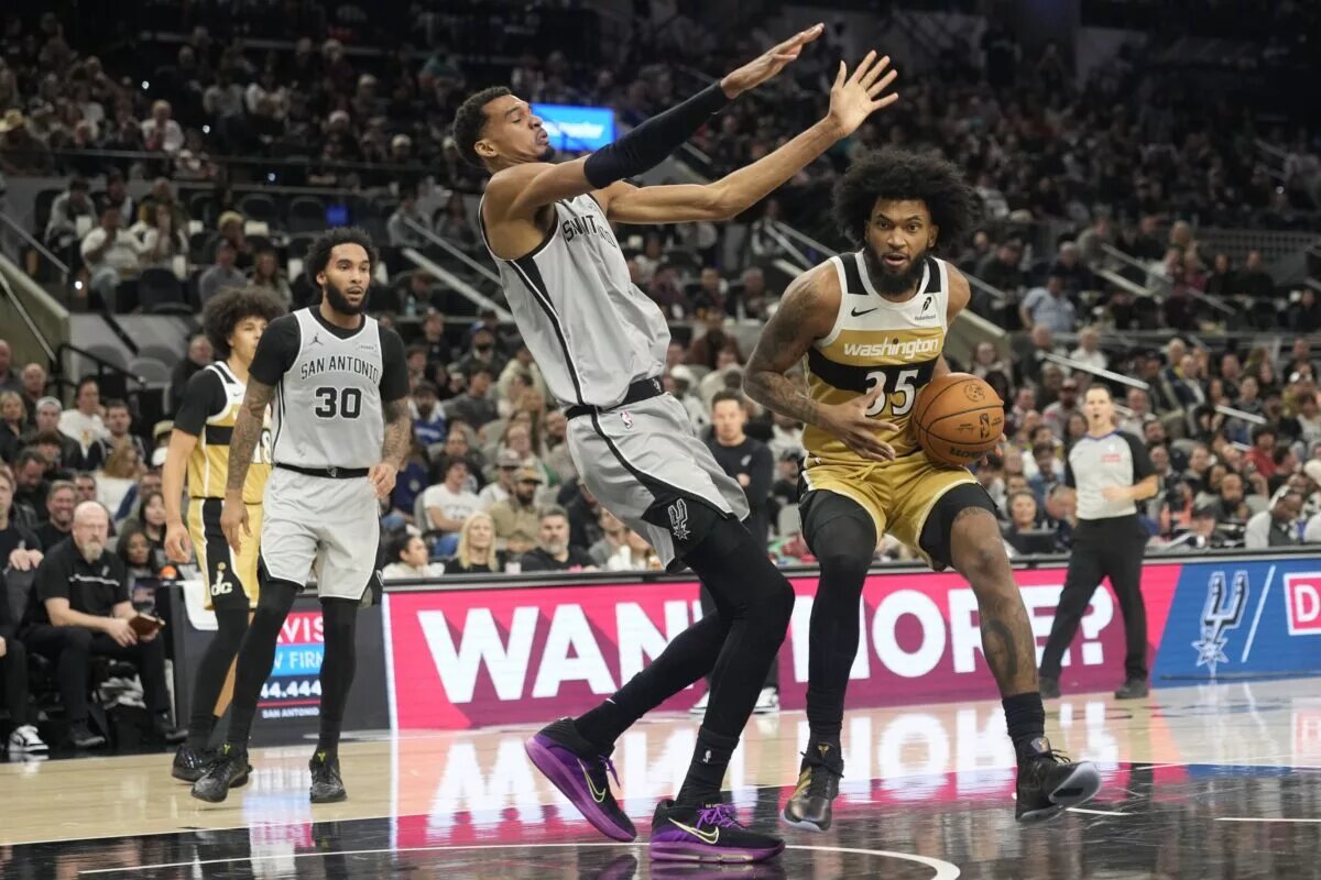 Washington Wizards forward Marvin Bagley III (35) draws a foul from San Antonio Spurs forward Victor Wembanyama (1) during the second half at Frost Bank Center.