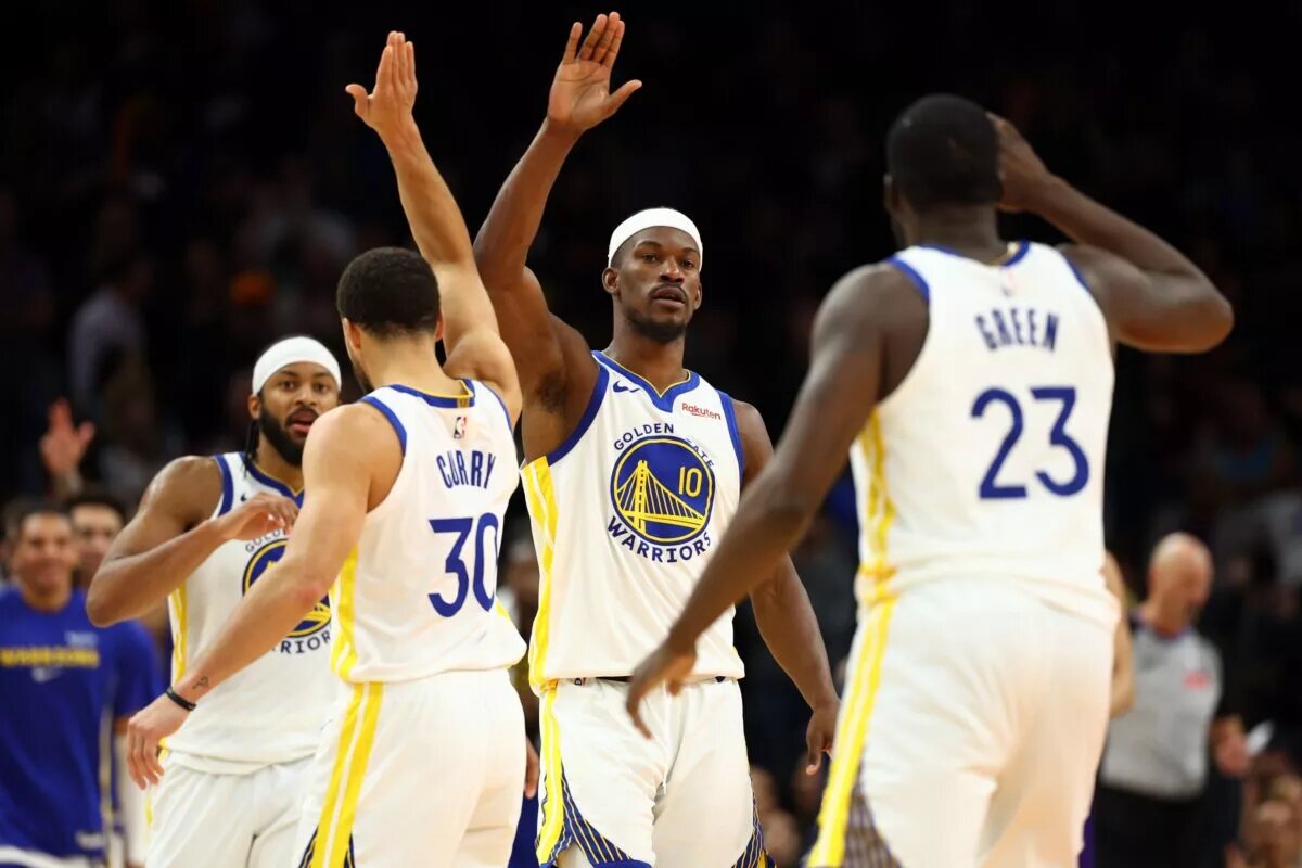 Dec 18, 2025; Phoenix, Arizona, USA; Golden State Warriors forward Jimmy Butler III (10) celebrates with guard Stephen Curry (30) and forward Draymond Green (23) against the Phoenix Suns in the second half at Mortgage Matchup Center. Mandatory Credit: Mark J. Rebilas-Imagn Images