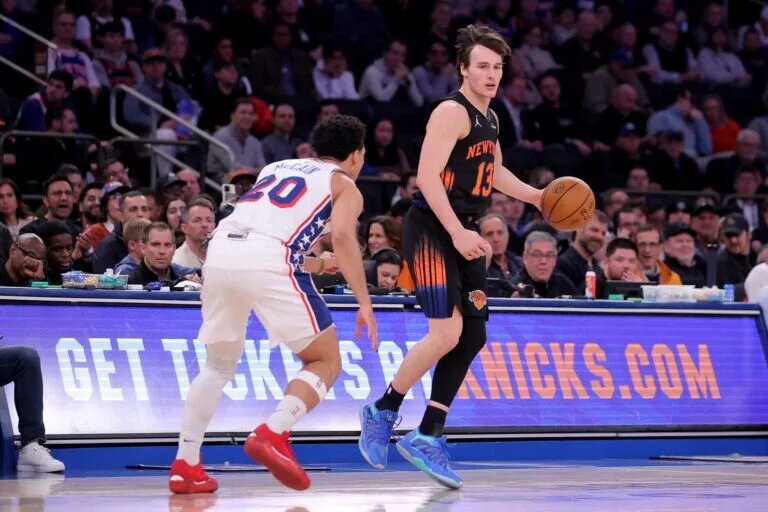 Dec 19, 2025; New York, New York, USA; New York Knicks guard Tyler Kolek (13) controls the ball against Philadelphia 76ers guard Jared McCain (20) during the second quarter at Madison Square Garden. Mandatory Credit: Brad Penner-Imagn Images