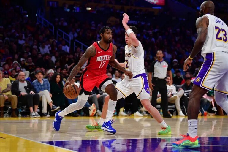 Dec 25, 2025; Los Angeles, California, USA; Houston Rockets forward Tari Eason (17) moves the ball against Los Angeles Lakers forward Jake LaRavia (12) during the second half at Crypto.com Arena. Mandatory Credit: Gary A. Vasquez-Imagn Images