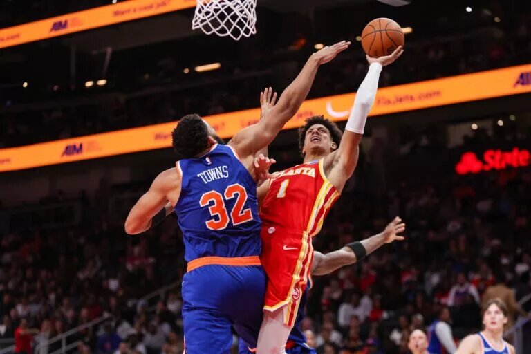 Atlanta Hawks forward Jalen Johnson (1) shoots around New York Knicks center Karl-Anthony Towns (32) in the fourth quarter at State Farm Arena.