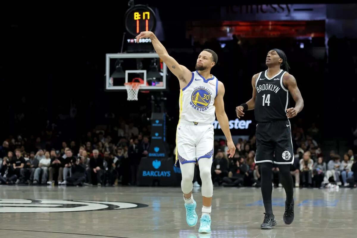 Golden State Warriors guard Stephen Curry (30) watches his three point shot against Brooklyn Nets guard Terance Mann (14) during the first quarter at Barclays Center.