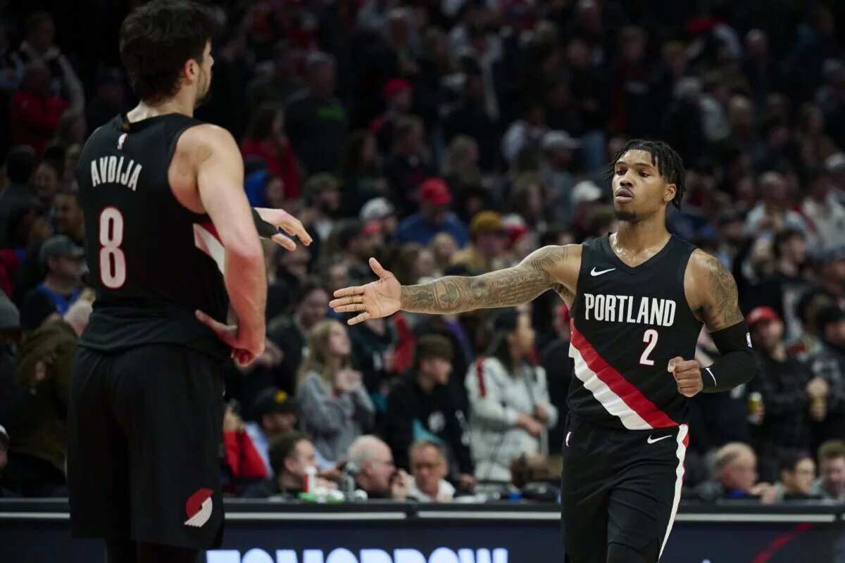 Dec 29, 2025; Portland, Oregon, USA; Portland Trail Blazers guard Caleb Love (2) high fives forward Deni Avdija (8) during the second half against the Dallas Mavericks at Moda Center. Mandatory Credit: Troy Wayrynen-Imagn Images