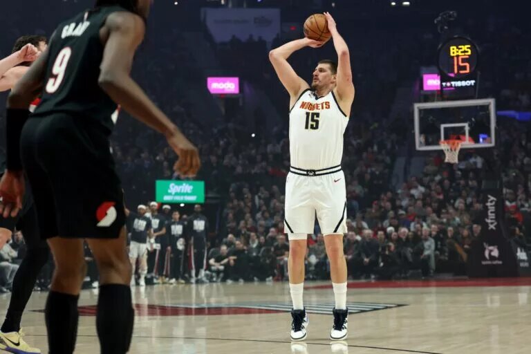 Feb 20, 2026; Portland, Oregon, USA; Denver Nuggets center Nikola Jokic (15) shoots against the Portland Trail Blazers during first half at Moda Center. Mandatory Credit: Jaime Valdez-Imagn Images