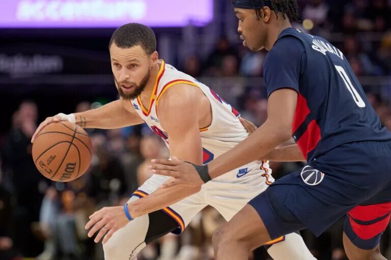 Jan 18, 2025; San Francisco, California, USA; Golden State Warriors guard Stephen Curry (30) drives with the ball against Washington Wizards guard Bilal Coulibaly (0) during the fourth quarter at Chase Center. Mandatory Credit: Robert Edwards-Imagn Images