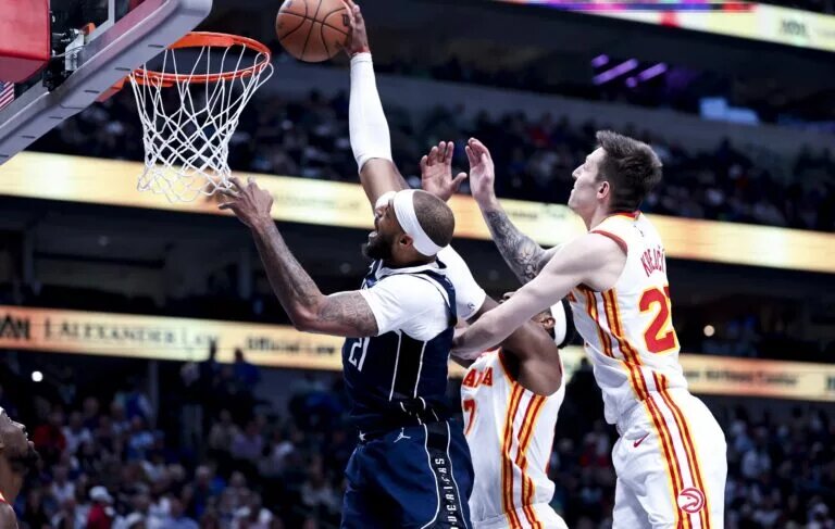 Dallas Mavericks center Daniel Gafford dunks past Atlanta Hawks defenders