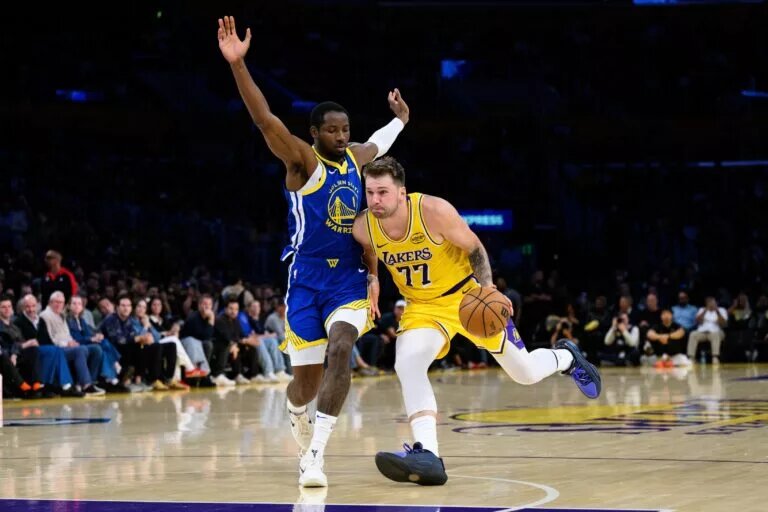 Golden State Warriors trade candidate Jonathan Kuminga defending Los Angeles Lakers guard Luka Doncic