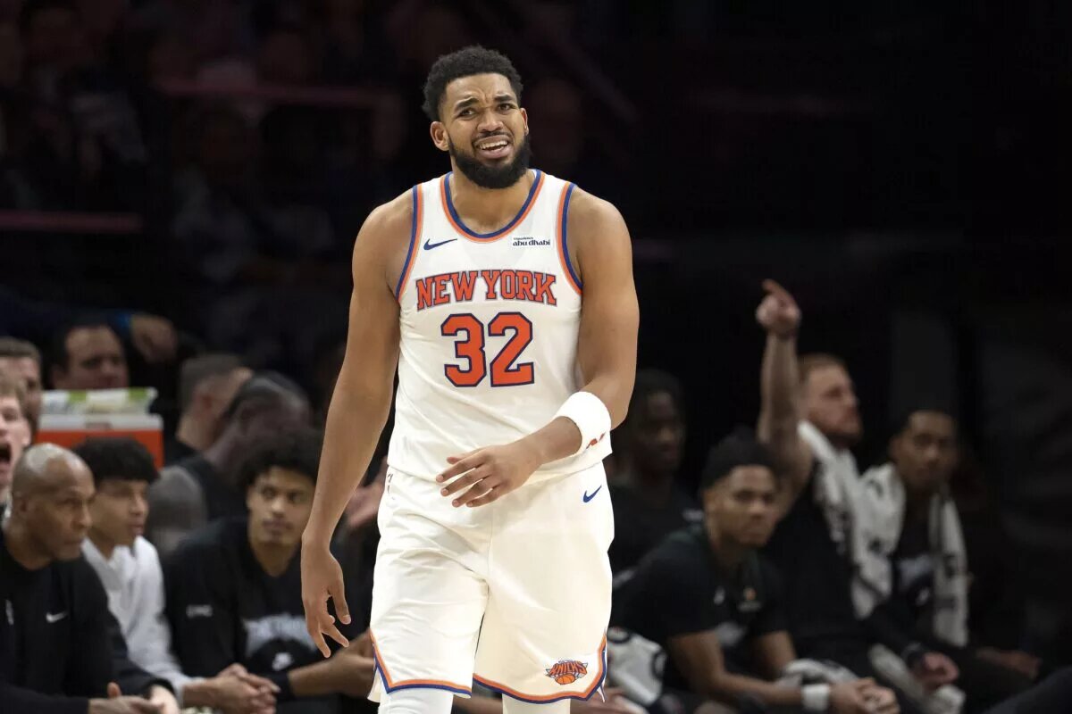 Dec 23, 2025; Minneapolis, Minnesota, USA; New York Knicks center Karl-Anthony Towns (32) lreacts after a foul is called against the Minnesota Timberwolves in the second half at Target Center. Mandatory Credit: Jesse Johnson-Imagn Images