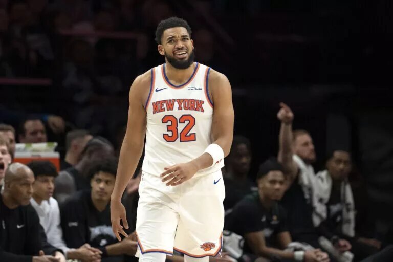 Dec 23, 2025; Minneapolis, Minnesota, USA; New York Knicks center Karl-Anthony Towns (32) lreacts after a foul is called against the Minnesota Timberwolves in the second half at Target Center. Mandatory Credit: Jesse Johnson-Imagn Images