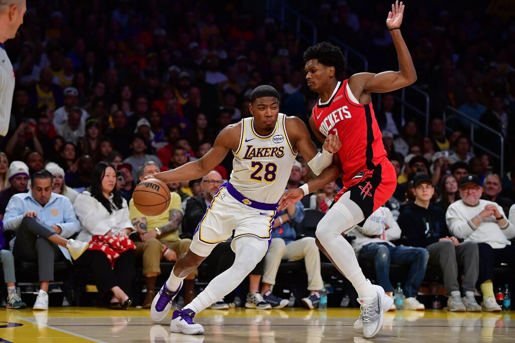 Dec 25, 2025; Los Angeles, California, USA; Los Angeles Lakers forward Rui Hachimura (28) moves to the basket against Houston Rockets guard Amen Thompson (1) during the first half at Crypto.com Arena. Mandatory Credit: Gary A. Vasquez-Imagn Images