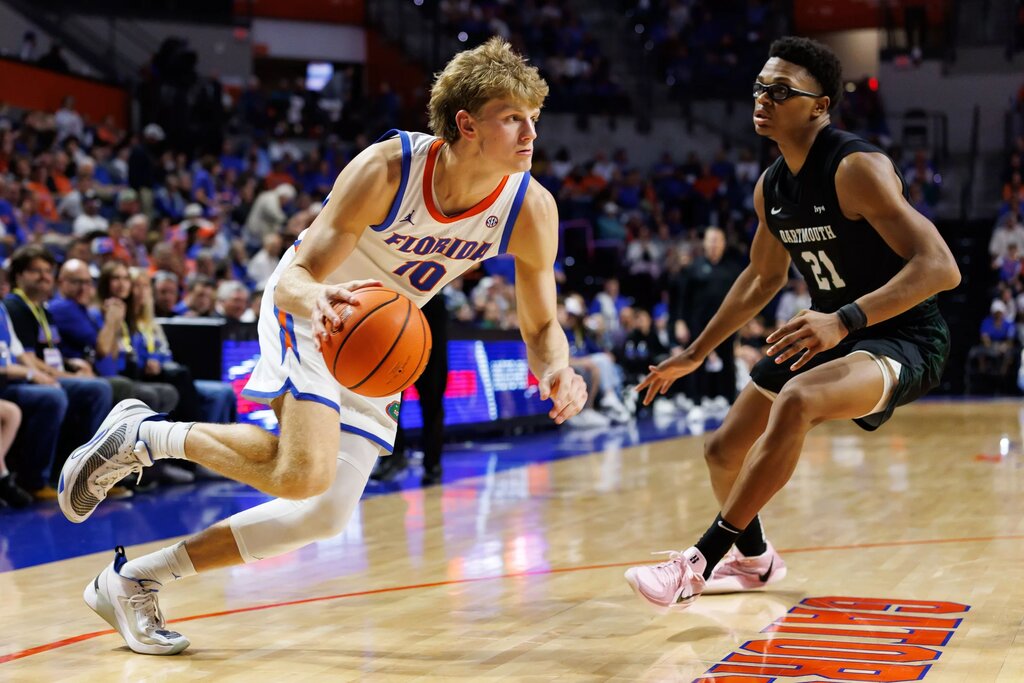 Florida Gators forward Thomas Haugh (10) drives to the basket past Dartmouth Big Green forward Brandon Mitchell-Day (21) during the second half at Exactech Arena at the Stephen C. O'Connell Center.