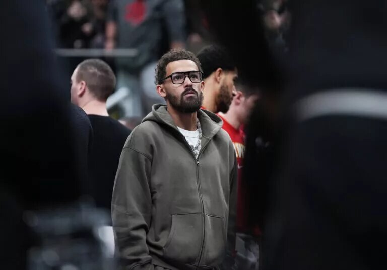 Atlanta Hawks guard Trae Young (11) watches the game from the bench during a time out in the second quarter against the Toronto Raptors at Scotiabank Arena.