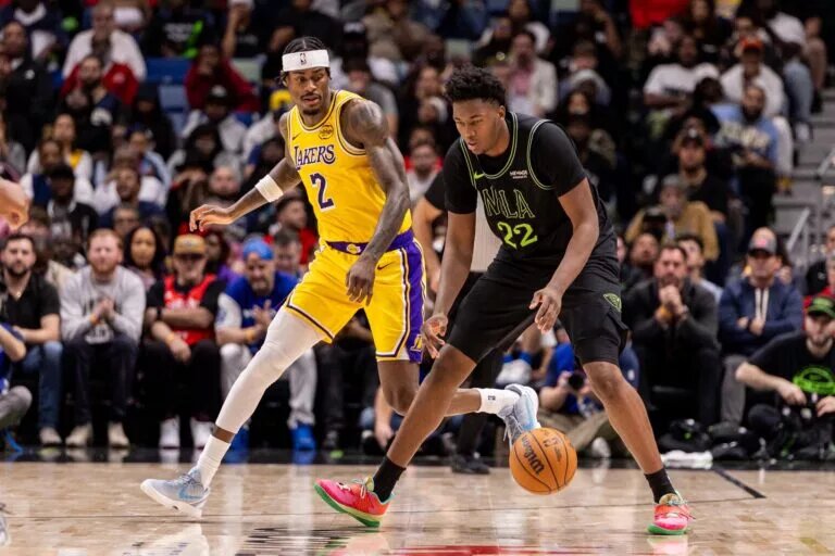 Jan 6, 2026; New Orleans, Louisiana, USA; New Orleans Pelicans center Derik Queen (22) dribbles against Los Angeles Lakers forward Jarred Vanderbilt (2) during the second half at Smoothie King Center. Mandatory Credit: Stephen Lew-Imagn Images
