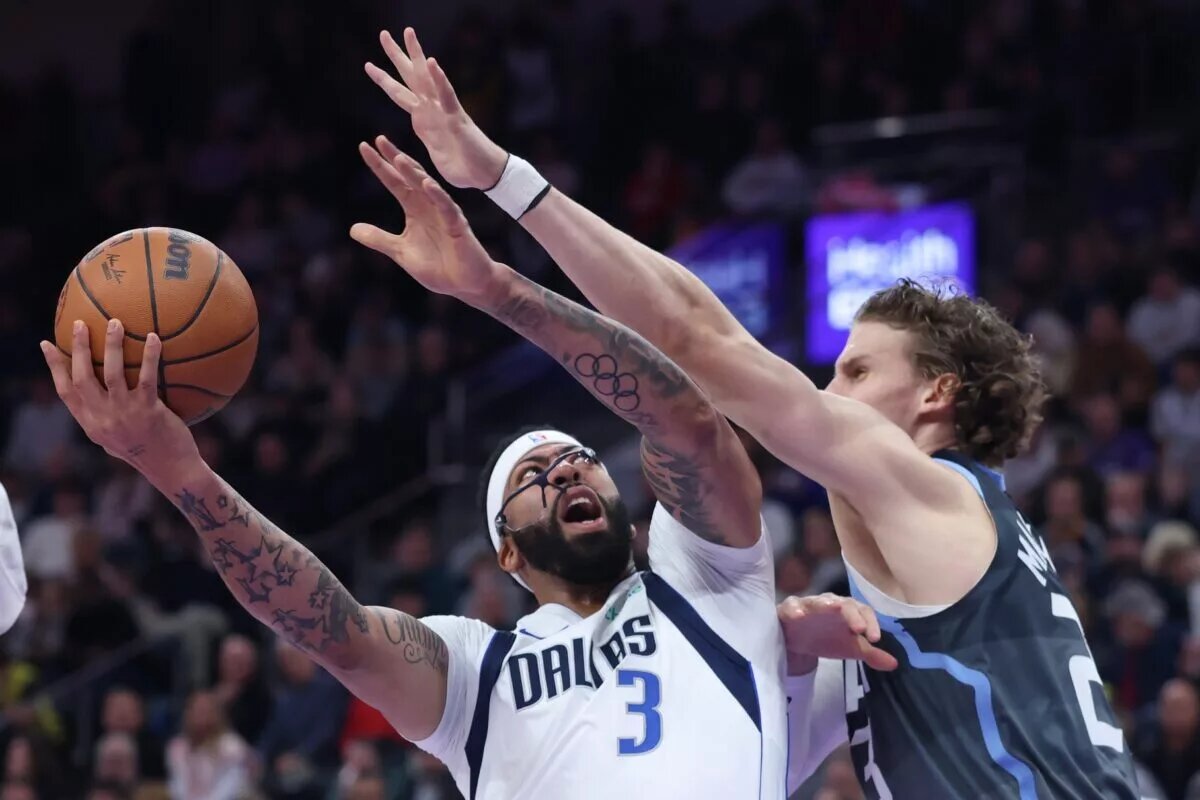 Jan 8, 2026; Salt Lake City, Utah, USA; Dallas Mavericks forward Anthony Davis (3) goes to the basket against Utah Jazz forward Lauri Markkanen (23) during the first quarter at Delta Center. Mandatory Credit: Rob Gray-Imagn Images