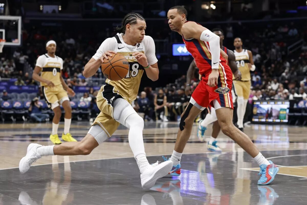 Washington Wizards forward Kyshawn George (18) drives to the basket as New Orleans Pelicans guard Bryce McGowens (11) defends in the second half at Capital One Arena.
