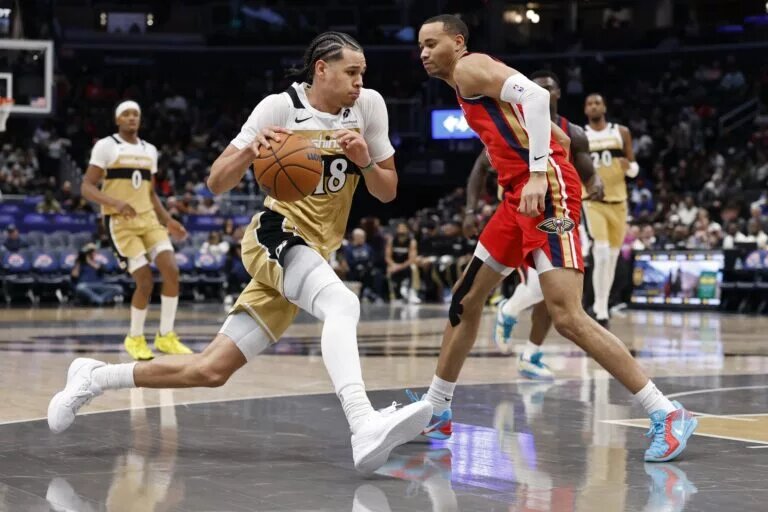 Washington Wizards forward Kyshawn George (18) drives to the basket as New Orleans Pelicans guard Bryce McGowens (11) defends in the second half at Capital One Arena.