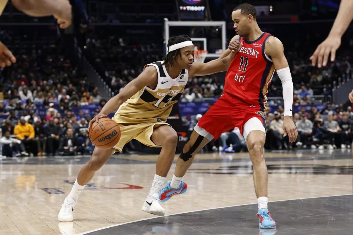 Jan 9, 2026; Washington, District of Columbia, USA; Washington Wizards guard Tre Johnson (12) drives to the basket as New Orleans Pelicans guard Bryce McGowens (11) defends in the second half at Capital One Arena. Mandatory Credit: Geoff Burke-Imagn Images