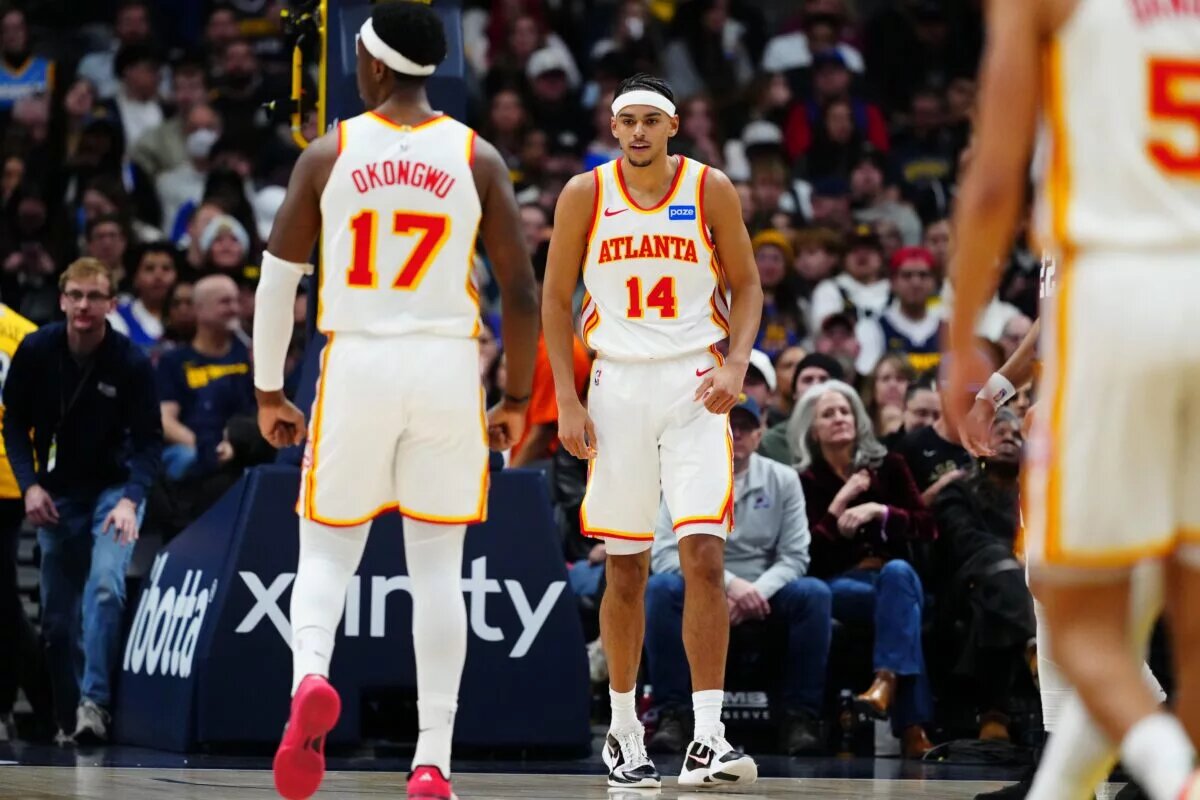 Jan 9, 2026; Denver, Colorado, USA;Atlanta Hawks forward Asa Newell (14) reacts after his dunk in the second quarter against the Denver Nuggets at Ball Arena. Mandatory Credit: Ron Chenoy-Imagn Images