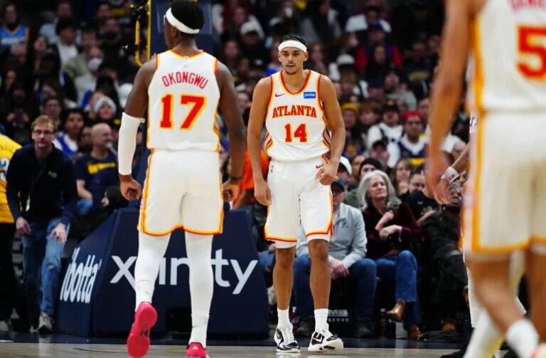 Jan 9, 2026; Denver, Colorado, USA;Atlanta Hawks forward Asa Newell (14) reacts after his dunk in the second quarter against the Denver Nuggets at Ball Arena. Mandatory Credit: Ron Chenoy-Imagn Images