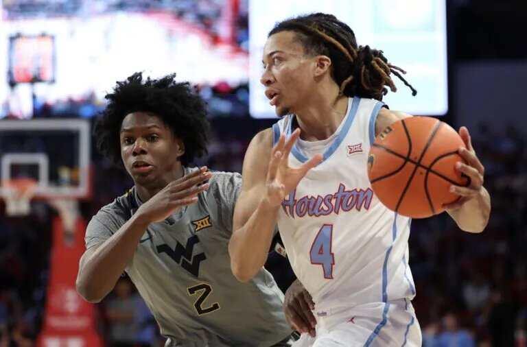 Houston Cougars guard Kingston Flemings (4) dribbles against West Virginia Mountaineers guard Amir Jenkins (2) in the first half at Fertitta Center.
