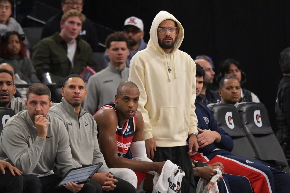 Washington Wizards guard Trae Young (3) (white hoodie) looks on from the bench in the second half against the Los Angeles Clippers at Intuit Dome.