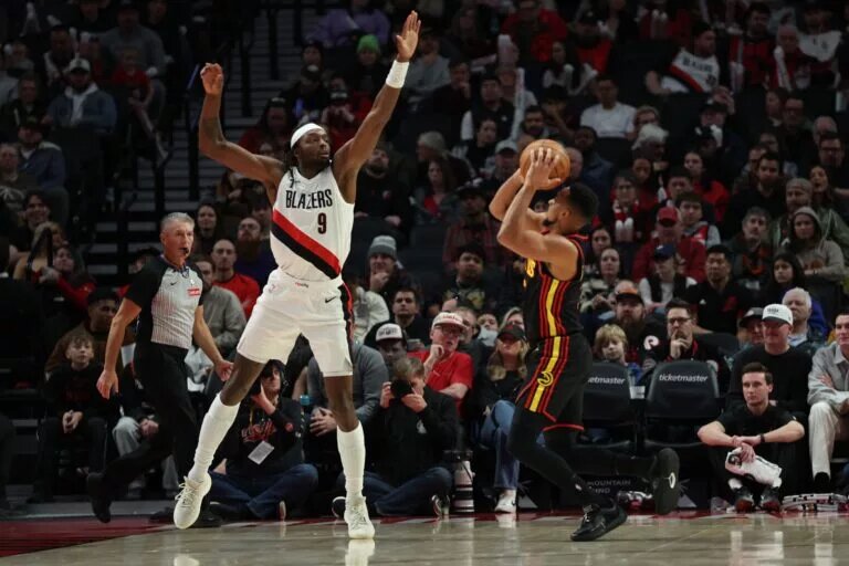 Portland Trail Blazers forward Jerami Grant (9) defends Atlanta Hawks guard CJ McCollum (3) during the first half at Moda Center.