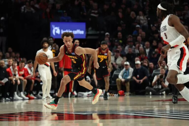 Atlanta Hawks guard Dyson Daniels (5) dribbles the ball past Portland Trail Blazers forward Jerami Grant (9) during the second half at Moda Center.