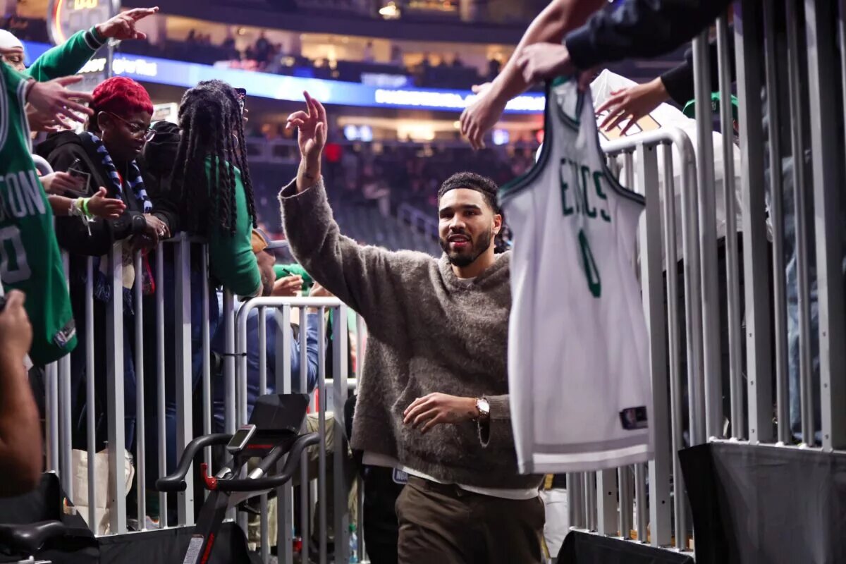 Boston Celtics forward Jayson Tatum walks into team tunnel cheered by fans