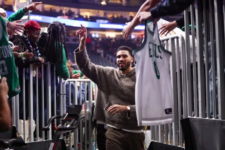 Boston Celtics forward Jayson Tatum walks into team tunnel cheered by fans