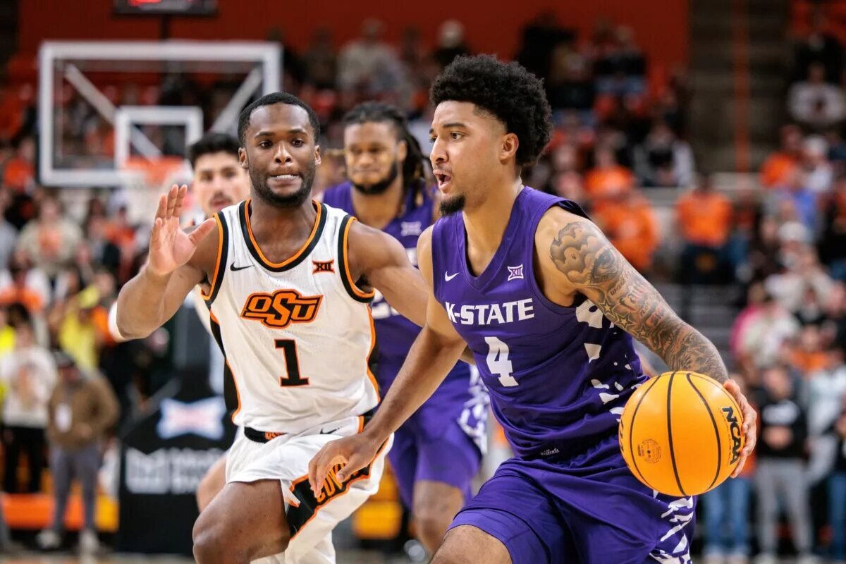 Jan 17, 2026; Stillwater, Oklahoma, USA; P.J. Haggerty (4) of the Kansas State Wildcats drives to the basket around Kanye Clary (1) of the Oklahoma State Cowboys during the second half at Gallagher-Iba Arena. Mandatory Credit: William Purnell-Imagn Images