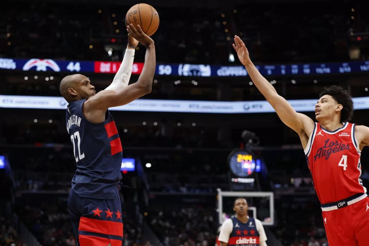 Jan 19, 2026; Washington, District of Columbia, USA; Washington Wizards forward Khris Middleton (22) shoots the ball as LA Clippers guard Kobe Sanders (4) defends in the first half at Capital One Arena. Mandatory Credit: Geoff Burke-Imagn Images