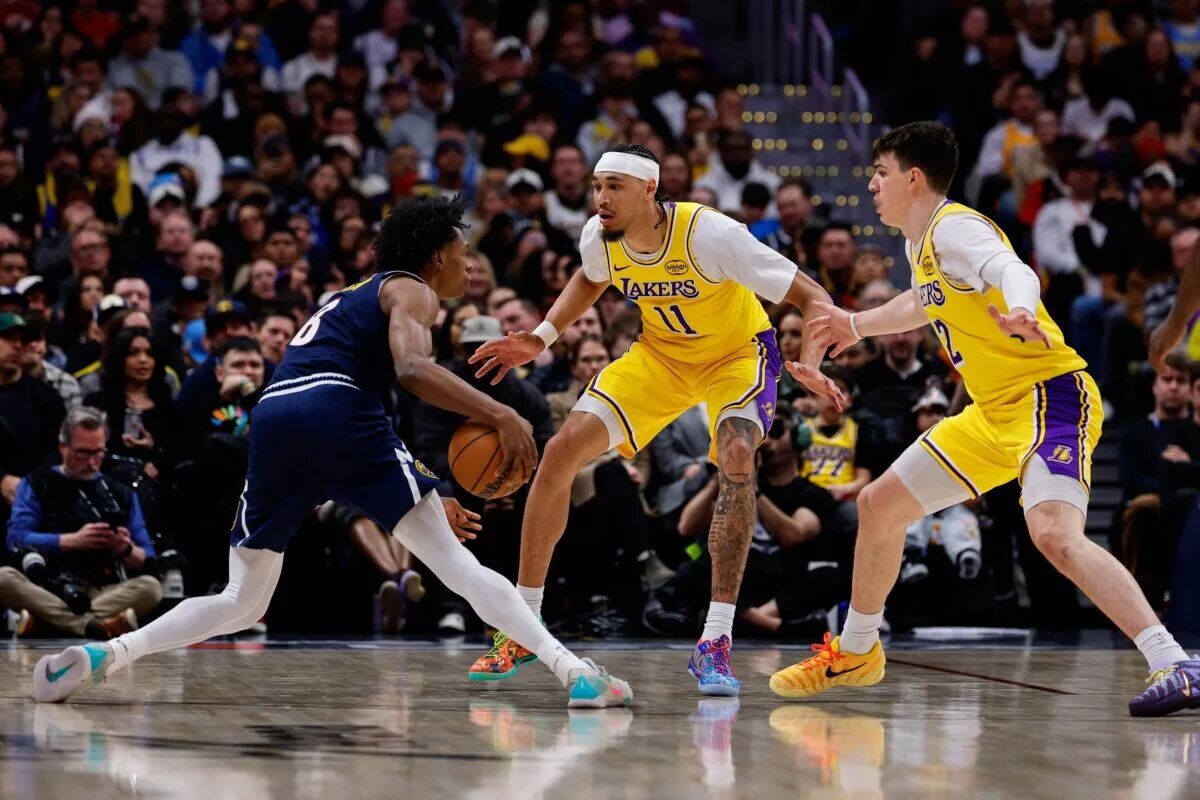 Jan 20, 2026; Denver, Colorado, USA; Denver Nuggets guard Peyton Watson (8) controls the ball as Los Angeles Lakers center Jaxson Hayes (11) and forward Jake LaRavia (12) guards in the third quarter at Ball Arena. Mandatory Credit: Isaiah J. Downing-Imagn Images